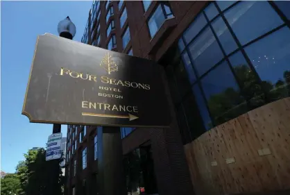 ?? Photograph: Suzanne Kreiter/Boston Globe/Getty Images ?? The Four Seasons hotel in Boston has let go many employees. New legislatio­n aims to require hotels to rehire workers by order of seniority.
