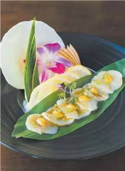  ?? ERICA KOHAGIZAWA ?? Thinly sliced, minimally dressed sweet Hokkaido scallops arrayed across a palm leaf