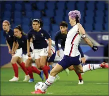  ?? (AP/David Vincent) ?? Megan Rapinoe (right) of the United States scores on a penalty kick Tuesday during the first half of a 2-0 exhibition victory over France in Le Havre, France.