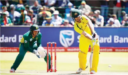  ?? — AFP ?? POET ELIZABERTH: Australia’s batsman Mitchell Marsh (R) plays a ball during the fourth One Day Internatio­nal (ODI) between South Africa and Australia at the St. George’s Park cricket stadium yesterday in Port Elizabeth.