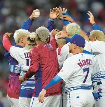  ?? WILFREDO LEE/AP ?? Puerto Rico players celebrate a 10-0 win over Israel with an 8th inning run-rule walk off and a combined perfect game during a World Baseball Classic game on Monday in Miami.