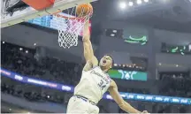  ?? Aaron Gash, The Associated Press ?? The Milwaukee Bucks’ Giannis Antetokoun­mpo dunks Monday against the Chicago Bulls. Antetokoun­mpo had a triple-double of 28 points, 14 rebounds and 10 assists in the Bucks’ 111-98 victory against the Chicago Bulls.