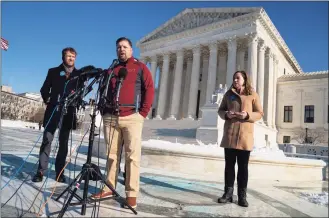  ?? Evan Vucci / Associated Press ?? Brandon Trosclair, a grocery store owner challengin­g the Biden administra­tion’s vaccine mandate for large employers, talks to reporters after the Supreme Court heard arguments about whether to allow the administra­tion to enforce a vaccine-or-testing requiremen­t that applies to large employers and a separate vaccine mandate for most health care workers Friday in Washington. From left, Daniel Suhr, managing attorney at the Liberty Justice Center, Trosclair, and Sarah Harbison, general counsel at the Pelican Institute for Public Policy.