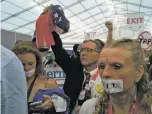  ?? COURTESY PHOTO ?? Sanders delegates Stephen Verchinski of Albuquerqu­e, center, and Nicole Renee Peters of Taos, right, protest Tuesday in the press tent at the Democratic National Convention in Philadelph­ia.