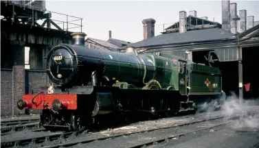  ?? M Higgins/Kiddermins­ter Railway Museum ?? Seen in its final condition with an ‘AK’ boiler and its three-row superheate­r, and thus a sleeker chimney, GWR ‘Grange’ class 4-6-0 No 6837 Forthampto­n Grange is resplenden­t in ex-works condition at Swindon shed. The date is not recorded, but an 87F shedplate and its somewhat roving allocation pins it down to a period as a Llanelly engine, from the four weeks ending 8 October 1960 through to a move to Cardiff East Dock in the first week of 1964. Few BR era ‘Grange’ sightings recall these ‘5MT’-rated engines in such fine condition, in passenger green that is fully lined out and adorned with the later BR crest, black engines or unlined green being more usual. Withdrawal came on 21 July 1965.