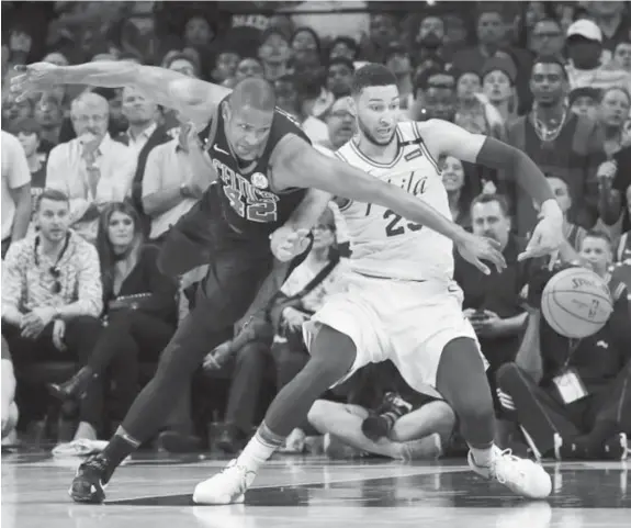  ??  ?? Celtics’ Al Horford, left, and Philadelph­ia 76ers’ Ben Simmons in a chase for ball possession.