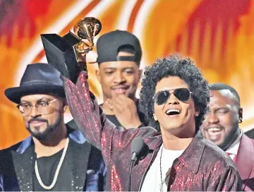  ??  ?? Bruno Mars receives his third Grammy for Album of the Year during the 60th Annual Grammy Awards. — AFP file photo