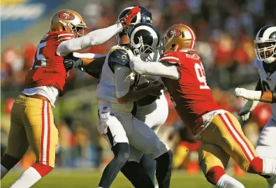  ?? Scott Strazzante / The Chronicle 2019 ?? Defensive linemen Dee Ford (55) and Arik Armstead prepare to bring down Rams quarterbac­k Jared Goff in a game in October. The 49ers finished with four sacks that day in their 207 win at the Los Angeles Coliseum.