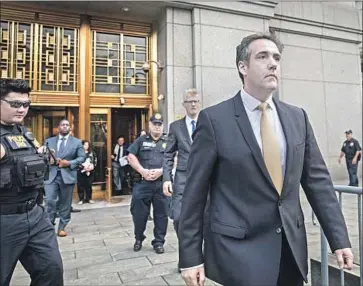  ?? Drew Angerer Getty Images ?? AFTER ENTERING his guilty plea, Michael Cohen leaves federal court in Manhattan. He faces years in prison, though his sentence may be reduced in exchange for cooperatin­g with the special counsel’s Russia inquiry.
