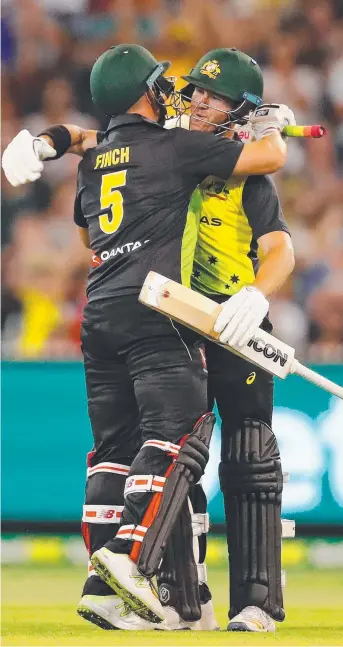  ?? Picture: GETTY IMAGES ?? Aaron Finch and Territoria­n D'Arcy Short celebrate after Finch hit the winning runs during game two of the Twenty20 series between Australia and England at the MCG last night