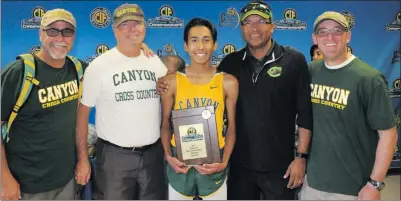  ?? Courtesy photo ?? Canyon cross country runner Ethan Danforth, center, stands with several coaches on Saturday. Danforth took home the CIFSouther­n Section Division 2 title on Saturday at the Riverside Cross Country Course.