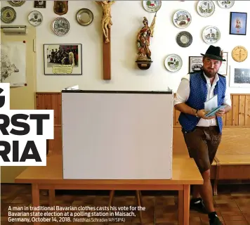  ?? (Matthias Schrader/AP/SIPA) ?? A man in traditiona­l Bavarian clothes casts his vote for the Bavarian state election at a polling station in Maisach, Germany, October 14, 2018.