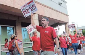  ?? LYNNE SLADKY/AP ?? People with National Nurses United march in support of Medicare for All, outside of the Democratic debate Wednesday in Miami.