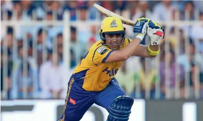  ?? — Photo by M. Sajjad ?? Kamran Akmal of Peshawar plays a shot against Lahore on Friday.