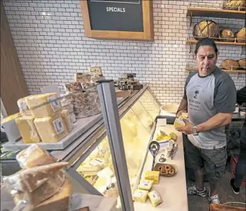  ??  ?? Owner Nick Ambeliotis has several hard-to-find artisan cheeses from Europe at his newly opened Mediterra Cafe in Sewickley. He also owns Mediterra Bakehouse in Robinson.