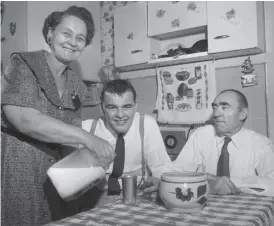  ?? GENE PESEK/SUN-TIMES ?? High schooler and future Bears linebacker Dick Butkus with his mother Emma and father John at their home at 10324 S. Lowe Ave. in 1959.