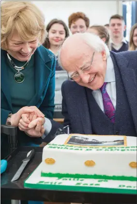  ??  ?? As it was his birthday two days before his visit, President Higgins was presented with a birthday cake made by Majella Healy of Graceland Cakes in Ballisodar­e.