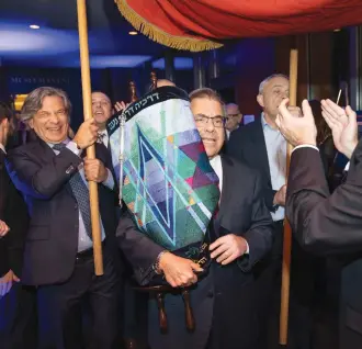  ?? (Brian Berkowitz) ?? RABBI SHLOMO RISKIN dances with the Torah at the Ohr Torah Stone annual dinner, 2019.