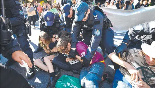  ??  ?? EXTRA POWERS: Police arrest Extinction Rebellion protesters blocking traffic in Brisbane earlier this month.