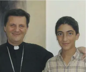  ??  ?? Bishop Mario Grech at the Curia in Gozo together with Alan as a young boy