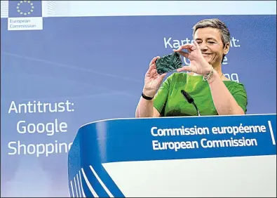  ?? AP/VIRGINIA MAYO ?? European Union Commission­er for Competitio­n Margrethe Vestager takes a photo with her cellphone during a news conference at EU headquarte­rs in Brussels on Tuesday. Vestager announced that Google had been fined for steering users toward its comparison...