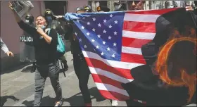  ?? (File Photo/AP/Martin Mejia) ?? Protesters against Peruvian President Martin Vizcarra, who faces an impeachmen­t vote, carry a U.S. flag with the letter Q, referring to QAnon, near Congress in Lima, Peru, on Nov. 9.