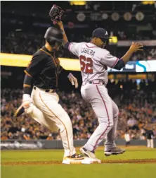  ?? D. Ross Cameron / Associated Press ?? Braves reliever Mauricio Cabrera tags first base ahead of the Giants’ Joe Panik to quell a budding rally in the eighth inning.