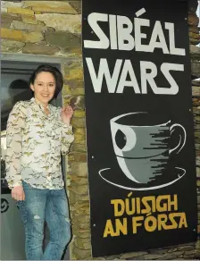  ??  ?? Iseult Ní Lubhaing with her Death Star themed Sibéal Wars: Dúisigh an Fórsa (The Force Awakens) poster, at her family’s shop in Baile ‘n Fheirtéara­igh.