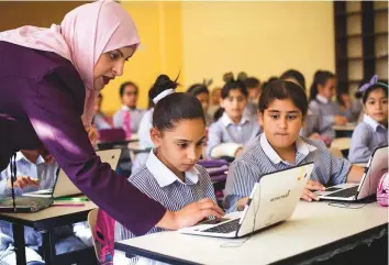  ?? AP ?? Palestinia­n children use laptops at the Ziad Abu Ein School in the occupied West Bank city of Ramallah. Educators are hoping the use of technology and arts will create new opportunit­ies.