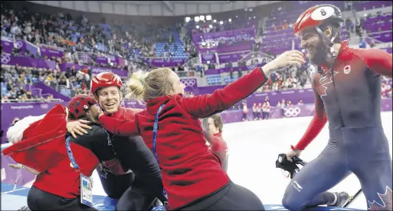  ?? AP PHOTO ?? Canadian skaters Pascal Dion, left, and Charles Hamelin celebrate with teammates after winning the bronze medal in the men’s 5,000 metres short track speedskati­ng relay final.