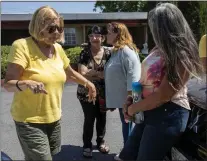  ?? ?? Homeless advocate Gail Osmer talks with a group of homeless people who received a nine-month motel stay paid for by Apple. That program ended last week.