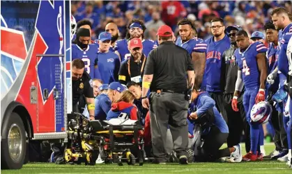  ?? ?? Buffalo Bills players and coaches look on in concern as Dane Jackson is treated by medical staff on the field. Photograph: Mark Konezny/ USA Today Sports