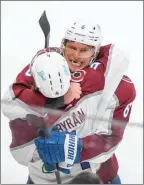  ?? The Associated Press ?? Colorado Avalanche Erik Johnson hugs Bowen Byram in Edmonton, June 6.