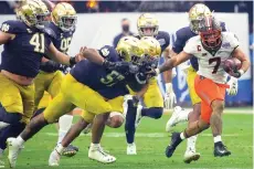  ?? AP Photo/Rick Scuteri ?? Oklahoma State running back Jaylen Warren (7) runs against Notre Dame Saturday during the second half of the Fiesta Bowl NCAA college football game in Glendale, Ariz.