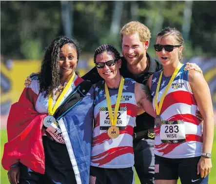  ?? — THE CANADIAN PRESS ?? Prince Harry poses with women’s 100m dash medallists: From left, Sabrina Daulaus of France (silver), Sarah Rudder of the U.S. (gold) and Christy Wise of the U.S. (bronze) on Sunday.