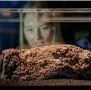  ?? AFP ?? A museum employee poses behind a piece of the fatberg on display at the Museum of London. —