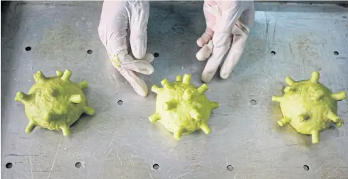  ?? REUTERS ?? A chef makes burgers shaped as coronaviru­s at a restaurant in Hanoi, Vietnam on Wednesday.