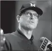  ?? AP/G-YUN JAM ?? Michigan football Coach Jim Harbaugh said he avoided doing any fun stuff while in Chicago for Big Ten media days, but told the media that the Wolverines must “strap on the iron jock and work like crazy” for fall practice.