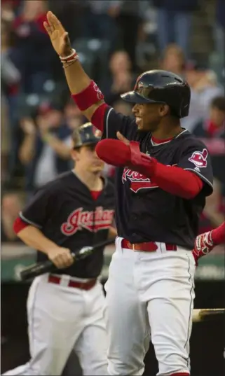  ?? PHIL LONG — ASSOCIATED PRESS ?? Francisco Lindor celebrates after scoring on a single by Jay Bruce during the first inning on Oct. 1 at Progressiv­e Field.