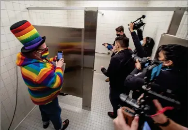  ?? KARL MONDON — STAFF PHOTOGRAPH­ER ?? Michael Petrelis, left, a longtime advocate of bathroom access in San Francisco, patiently waits for news crews to photograph the reopened and remodeled restroom at the Powell Street BART station in San Francisco on Wednesday. It had been closed since 2001.