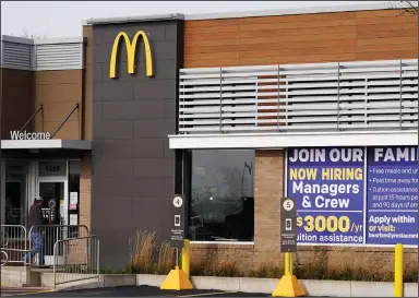  ?? (AP/Nam Y. Huh) ?? A hiring sign sits Thursday outside of McDonald’s in Buffalo Grove, Ill. The number of applicatio­ns for unemployme­nt benefits nationally rose sharply last week.