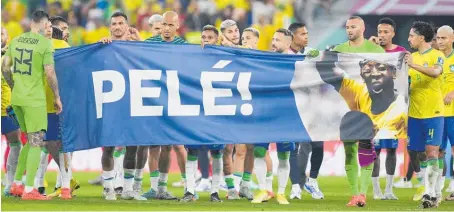  ?? Photos / AP ?? Brazil players hold a banner with a message of support for ailing former star, Pele.