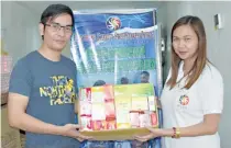  ??  ?? MSD personnel Margarette Dauz hands over medicines to Oliver de Guzman of Trento Gaming and Leisure Corp. in General Santos City.