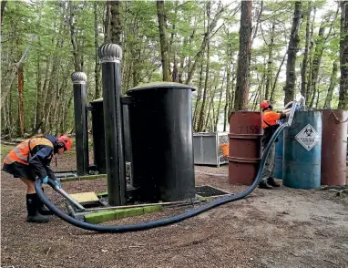  ?? DAVE NICOLL/FAIRFAX NZ ?? Workers pump sewage from a Conservati­on Department toilet at Brod Bay campsite on the Kepler Track.