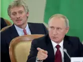  ?? (Ansa / Pool Shemetov) ?? Chi è
In primo piano il presidente russo Vladimir Putin Sullo sfondo Dmitry Peskov che è portavoce del Cremlino dal maggio del 2012