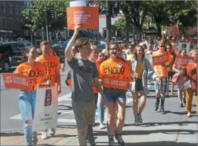  ?? JOSEPH PHELAN -- JPHELAN@DIGITALFIR­STMEDIA.COM ?? Students walked Broadway in Saratoga Springs Saturday with signs following anti-gun violence speeches in Congress Park.