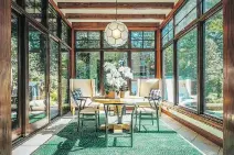  ?? PHOTO COURTESY OF ALAIN COURCHESNE, GAZETTE FILES ?? Floor-to-ceiling windows in this sunroom bring in the light, and the vibrant green rug makes the space feel warm and alive even in winter months.