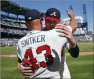  ?? JOHN BAZEMORE — THE ASSOCIATED PRESS ?? Atlanta Braves starting pitcher Sean Newcomb, right, hugs manager Brian Snitker (43) after defeating the Los Angeles Dodgers in a baseball game Sunday in Atlanta. Newcomb lost a no-hitter in the ninth inning.