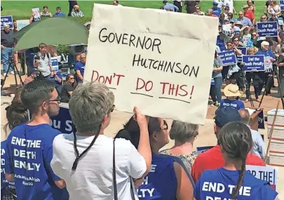  ?? KELLY P. KISSEL/AP ?? Hundreds of protesters gather outside the state Capitol building Friday in Little Rock, Ark., to voice opposition to Arkansas’ eight scheduled executions by waving signs including a large banner that read, “We remember the victims ... But not with more...