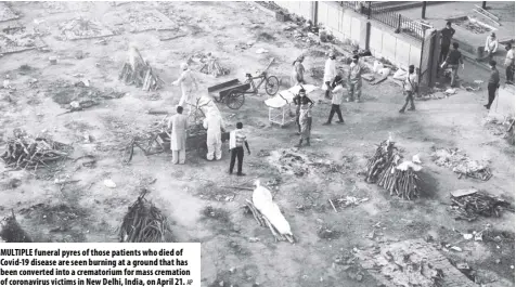  ?? AP ?? Multiple funeral pyres of those patients who died of Covid-19 disease are seen burning at a ground that has been converted into a crematoriu­m for mass cremation of coronaviru­s victims in New Delhi, india, on April 21.